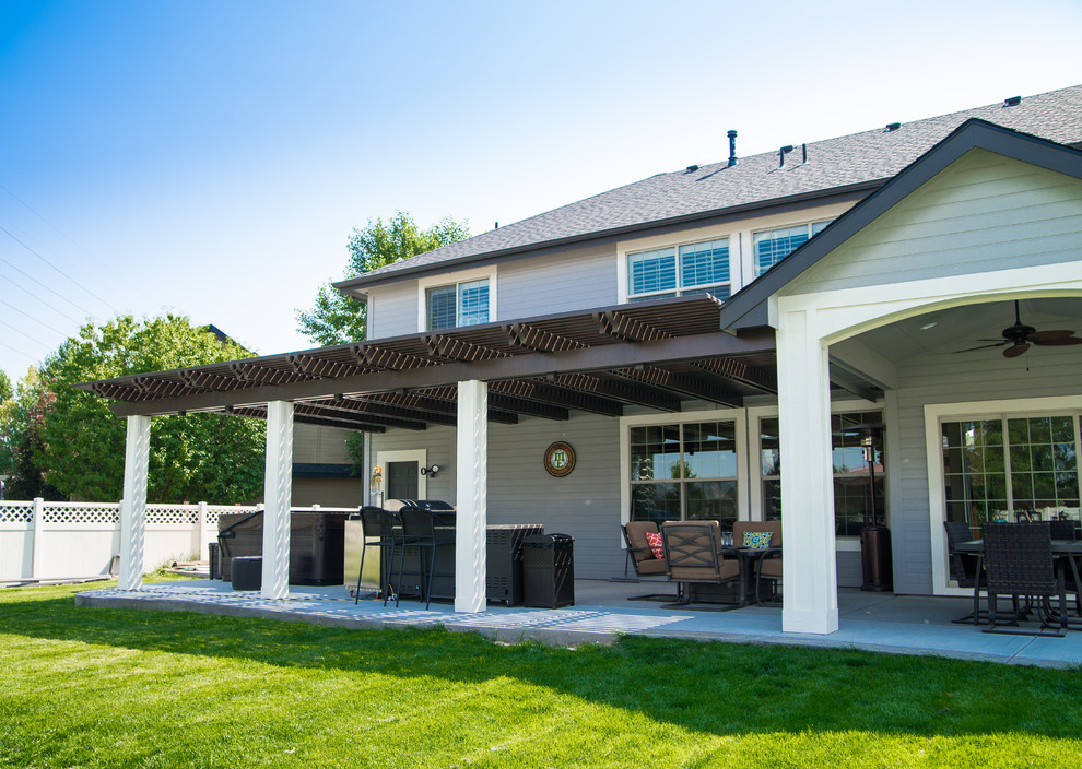 Design ideas for a large contemporary back patio in Boise with an outdoor kitchen and a pergola.