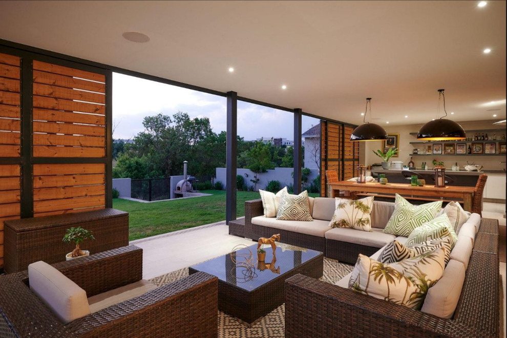 Inspiration for a large contemporary back patio in Other with tiled flooring.