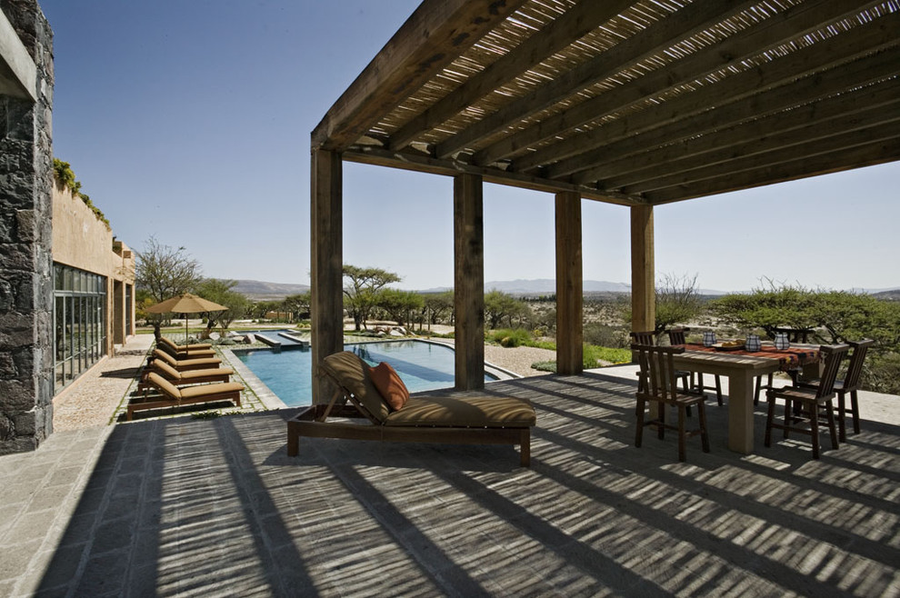 Patio - mediterranean patio idea in New York with a pergola