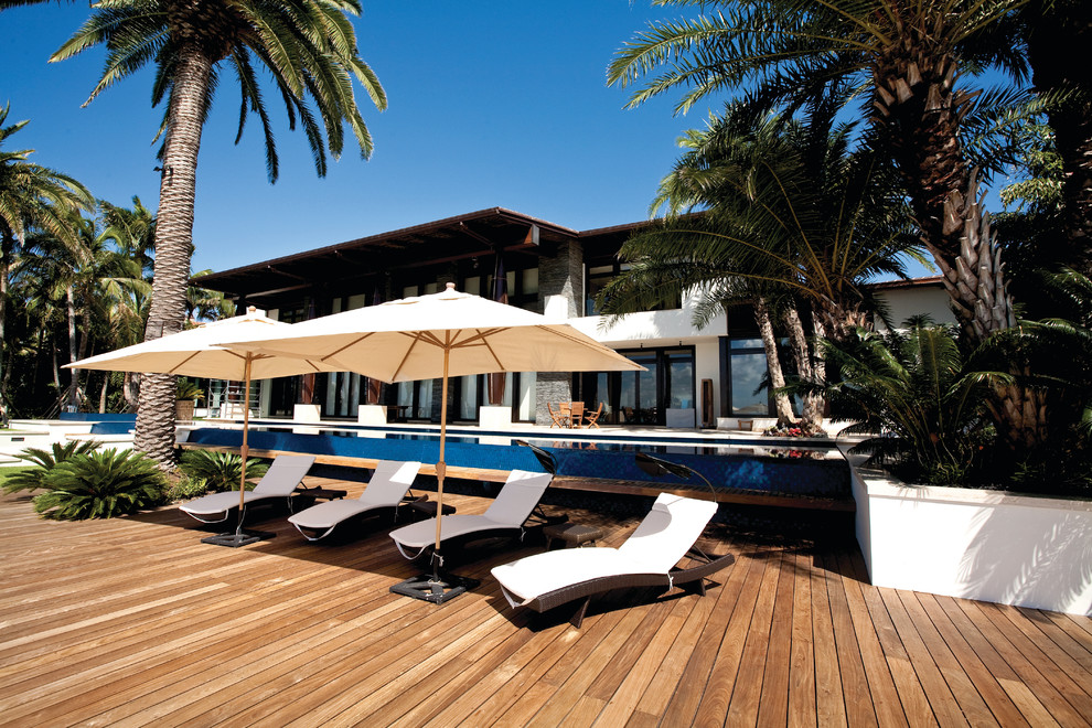 Inspiration for a tropical patio remodel in Miami with decking