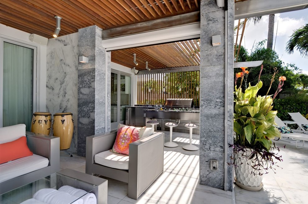 This is an example of a contemporary patio in Miami with a pergola and a bbq area.