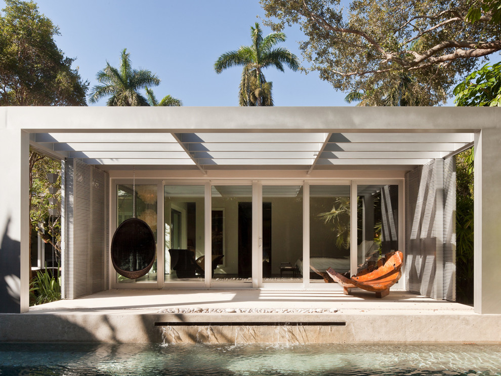 Photo of a world-inspired patio in Miami with a pergola.