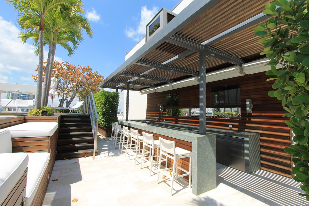 Inspiration for a modern backyard patio remodel in Miami with a fire pit, decking and a pergola