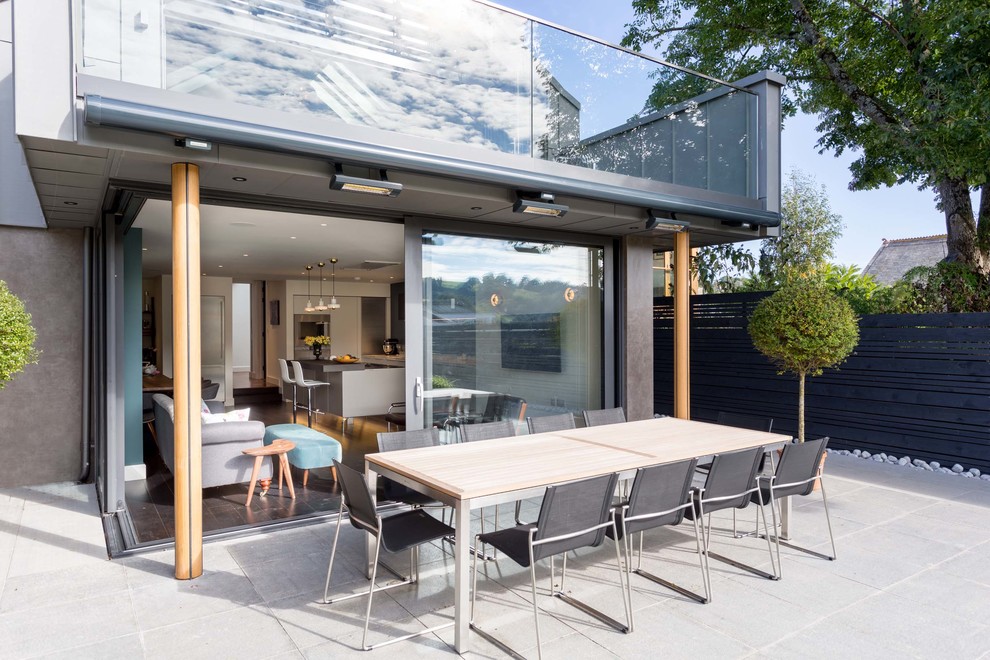 Patio - large contemporary backyard concrete paver patio idea in Devon with no cover