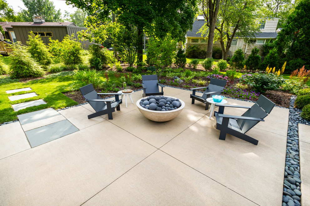Foto de patio moderno de tamaño medio en patio trasero con brasero y losas de hormigón