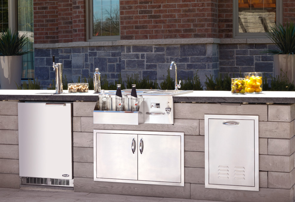 Inspiration for a large contemporary back patio in Toronto with an outdoor kitchen, concrete slabs and no cover.