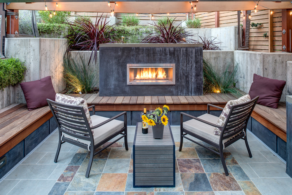 Photo of a medium sized contemporary patio in San Francisco with tiled flooring, no cover and a fireplace.