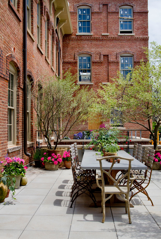 Elegant patio container garden photo in New York with no cover