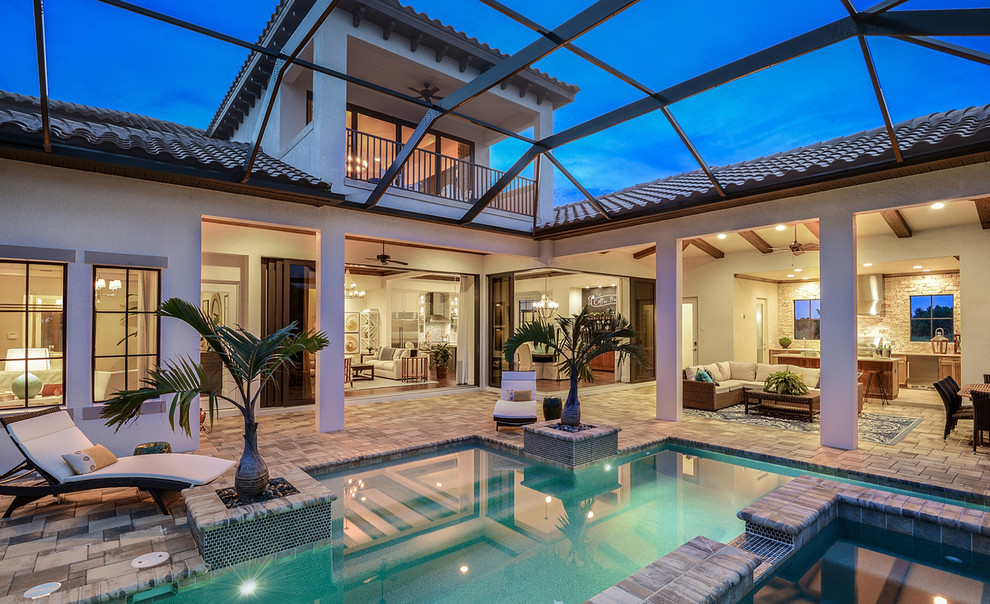 World-inspired back patio in Miami with a water feature and a pergola.