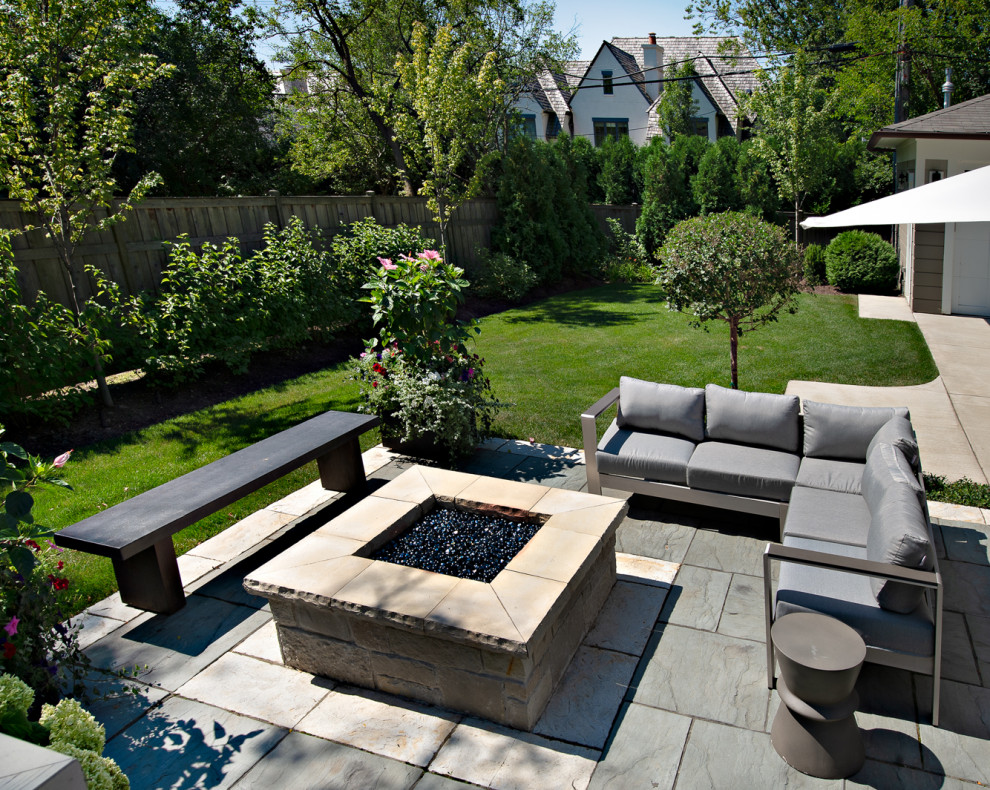 Inspiration for a mid-sized contemporary backyard patio remodel in Chicago with a fire pit