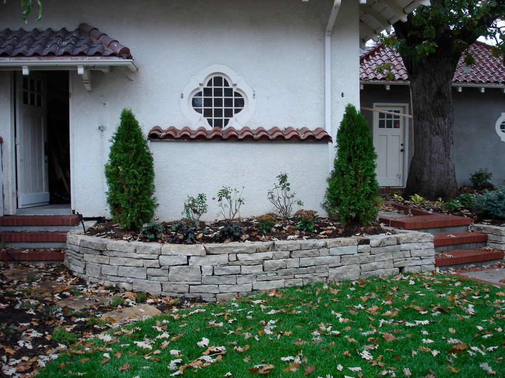 Mid-sized tuscan backyard stone patio photo in Minneapolis with no cover
