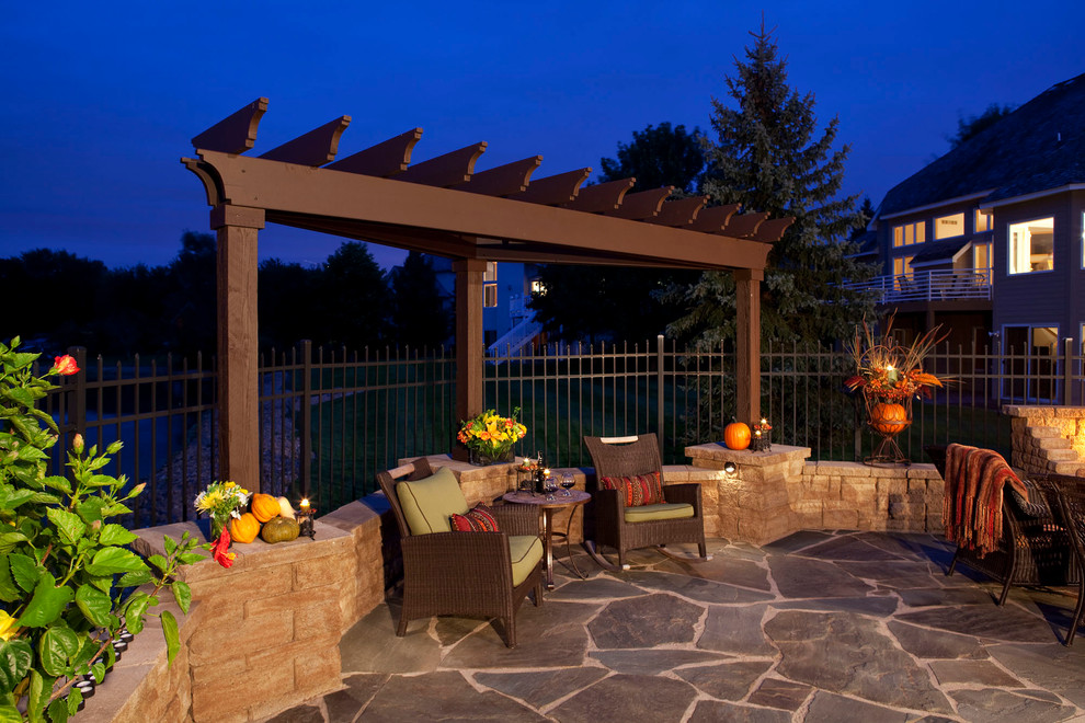 Mid-sized elegant backyard stone patio photo with a fire pit and a pergola