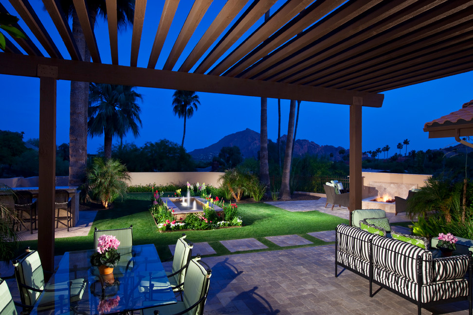Large traditional back patio in Phoenix with brick paving and a pergola.