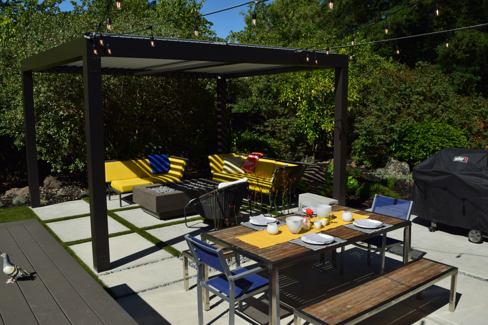 Example of a large minimalist backyard concrete paver patio design in San Francisco with a fire pit and a pergola