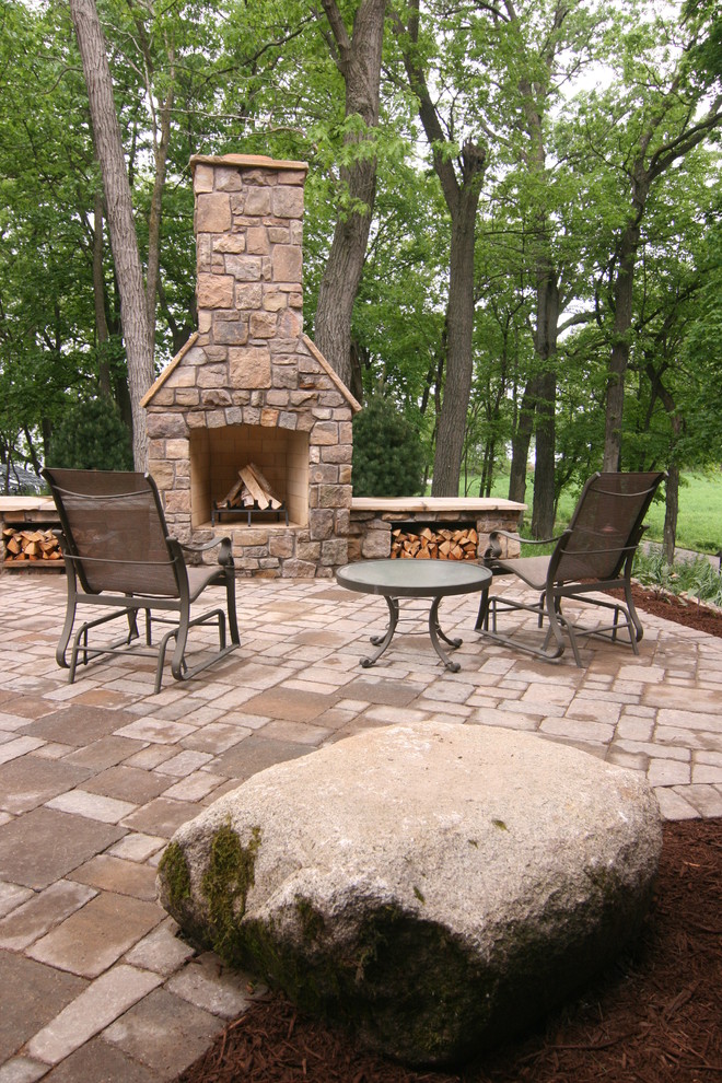 Design ideas for a large rustic side patio in Minneapolis with a fire feature, concrete paving and no cover.