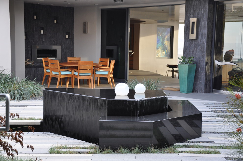 This is an example of a modern patio in San Luis Obispo with a water feature.