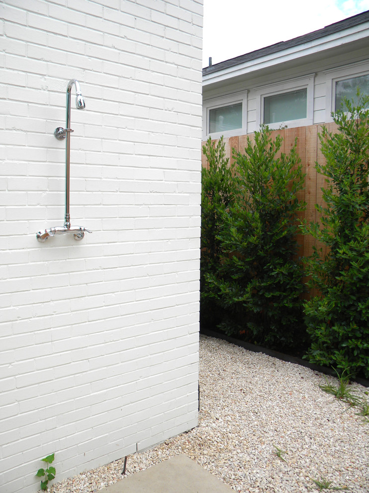 На фото: двор в стиле ретро с покрытием из гравия и летним душем с