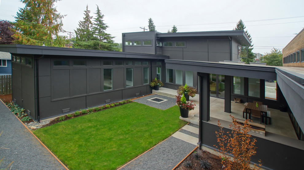 Exemple d'une grande terrasse moderne avec une cuisine d'été, une cour, une dalle de béton et une extension de toiture.