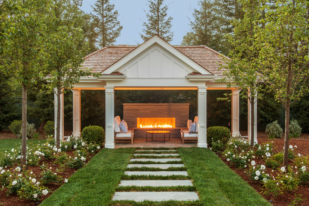 This is an example of a farmhouse back patio in San Francisco with a gazebo.