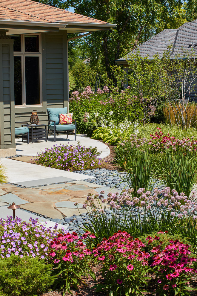 Inspiration for a medium sized midcentury front patio in Milwaukee with natural stone paving.