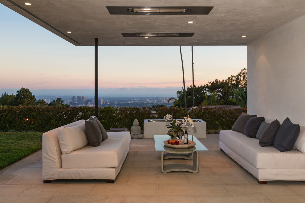 Inspiration for a mid-sized modern backyard tile patio remodel in Los Angeles with a roof extension