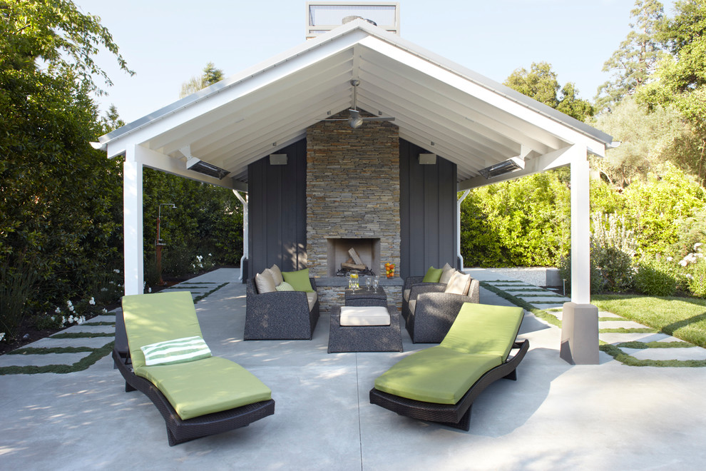 Trendy concrete patio photo in San Francisco with a fire pit and a roof extension