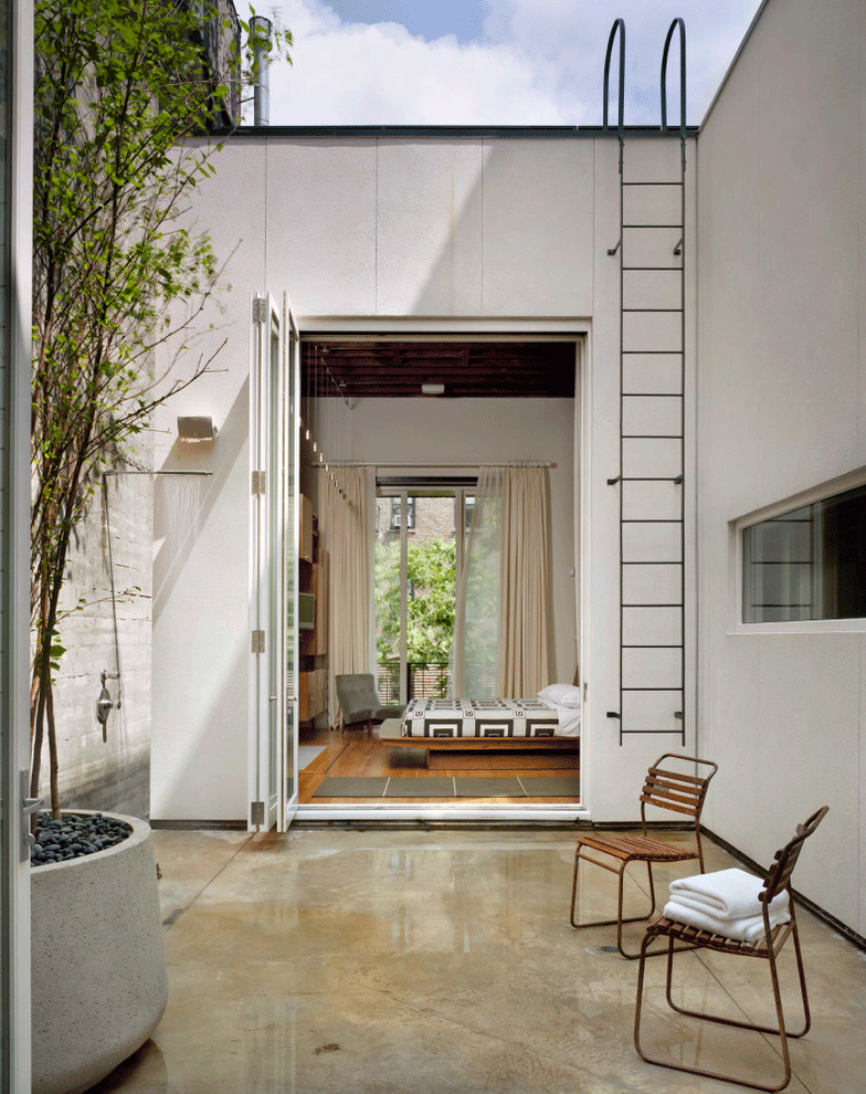 This is an example of a contemporary courtyard patio in New York with no cover.