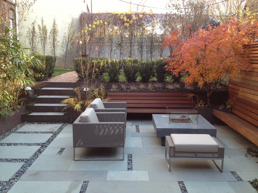 Inspiration for a modern patio in New York with a fire feature.