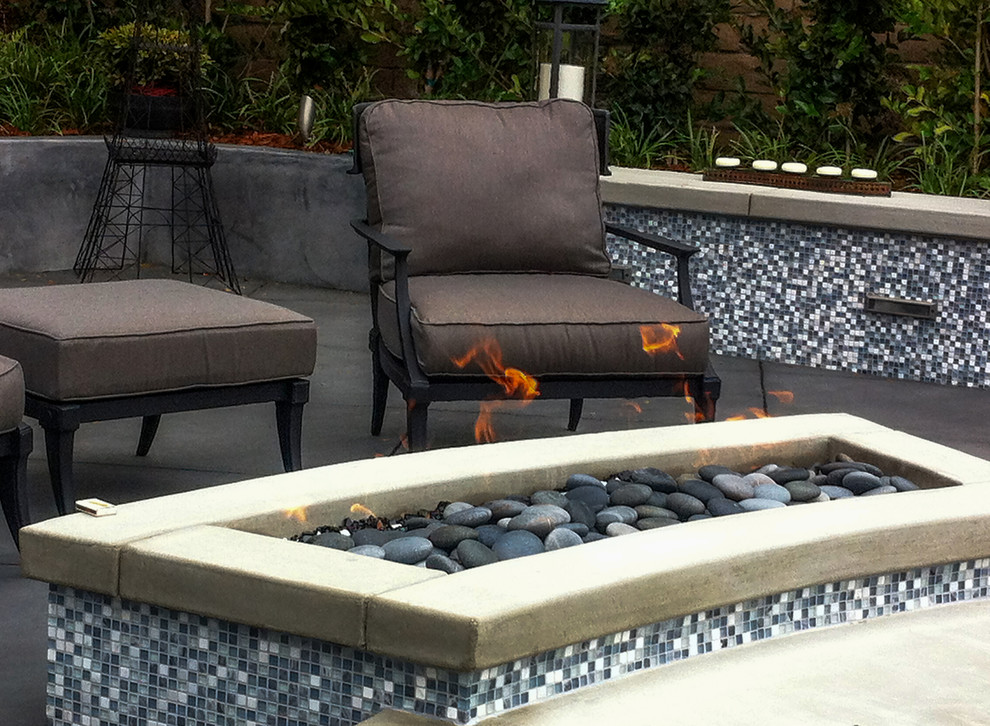 Patio - small modern backyard concrete patio idea in San Francisco with a fire pit and a pergola
