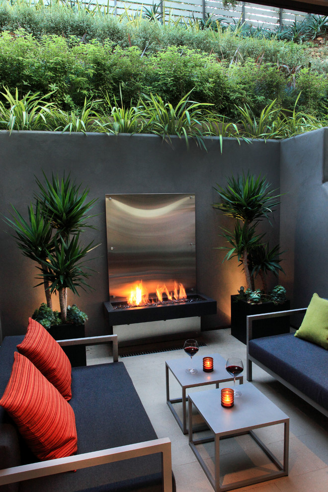 Example of a trendy patio design in San Diego with a fire pit