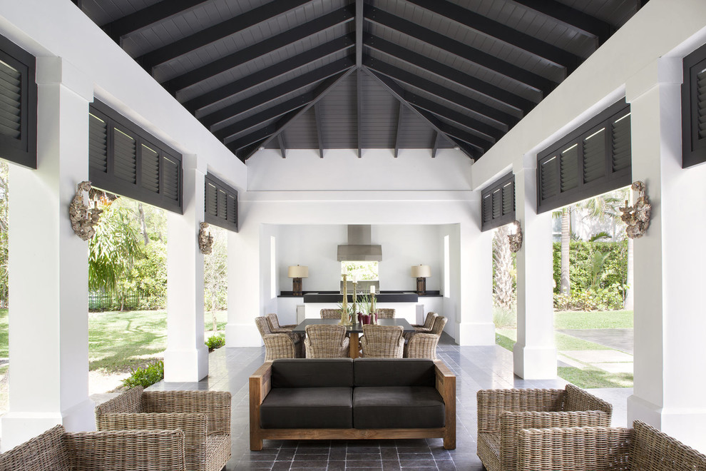 Example of a transitional patio design in Miami with a gazebo