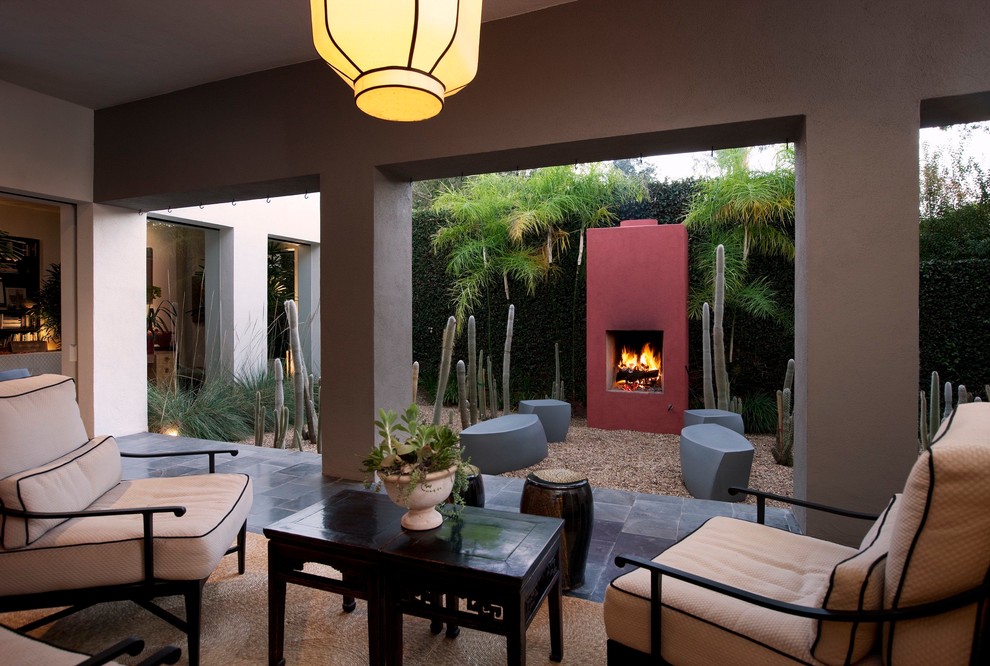 Example of a trendy gravel patio design in Santa Barbara with a fire pit