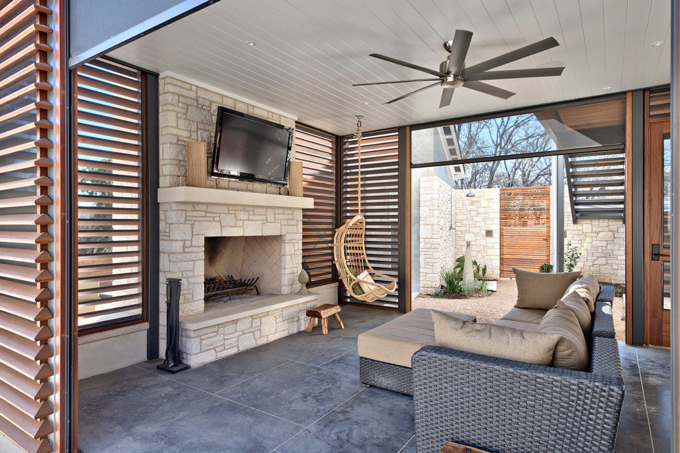 Design ideas for an expansive rural patio in Austin with a roof extension and a fireplace.