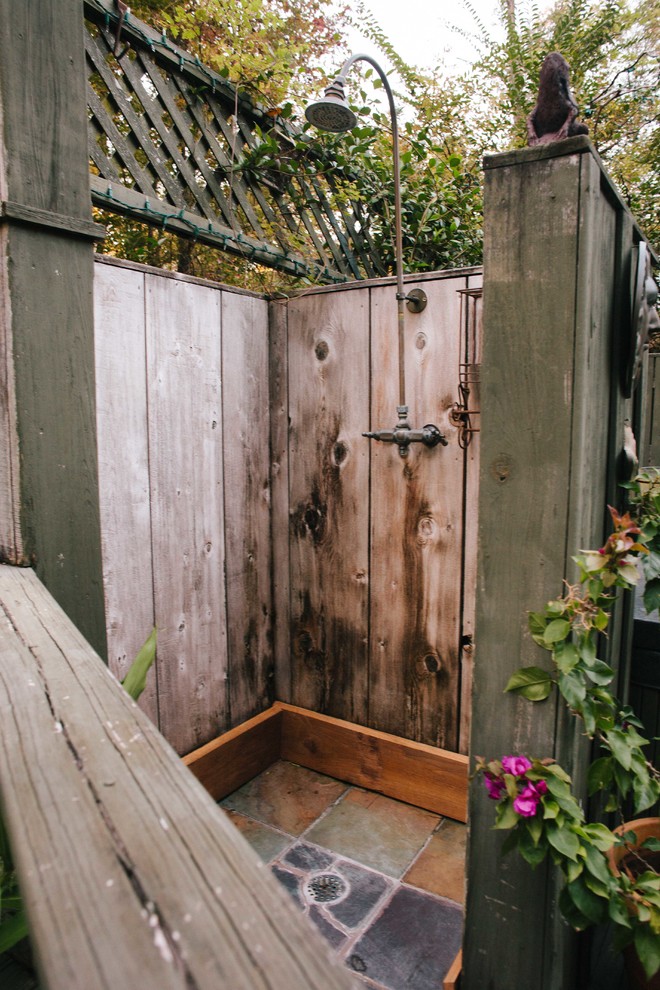 Rustic patio in New Orleans with an outdoor shower.