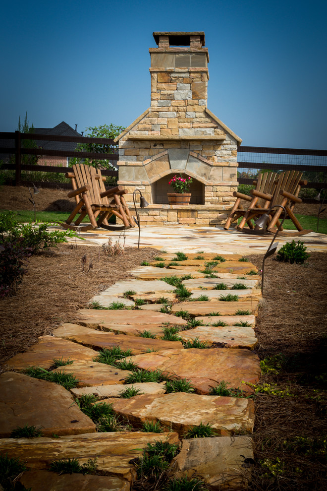 Inspiration for a rustic back patio in Atlanta with a fire feature, natural stone paving and no cover.