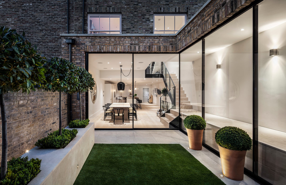 Medium sized contemporary patio in London.