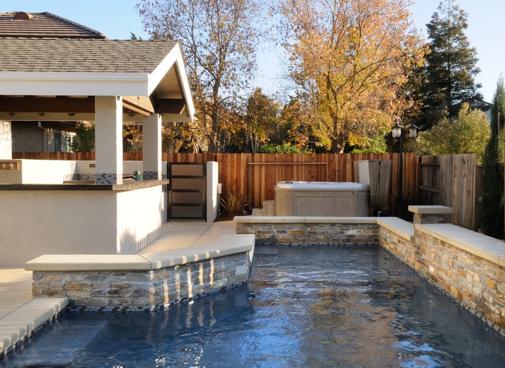 Example of a mid-sized trendy backyard concrete patio kitchen design in Sacramento with a roof extension