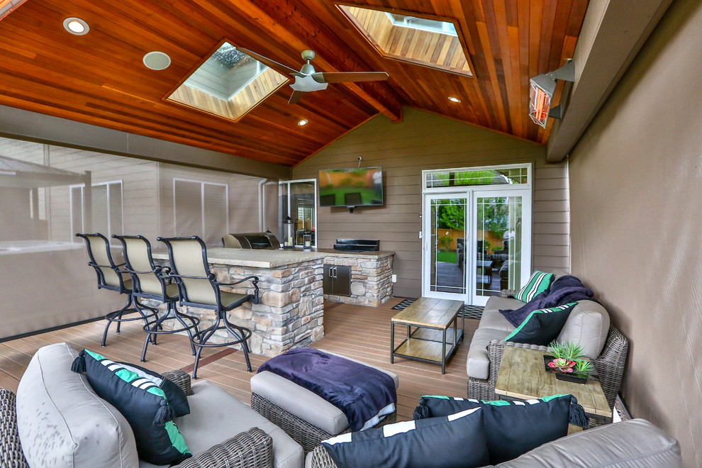 Inspiration for a large traditional back patio in Seattle with an outdoor kitchen and a roof extension.