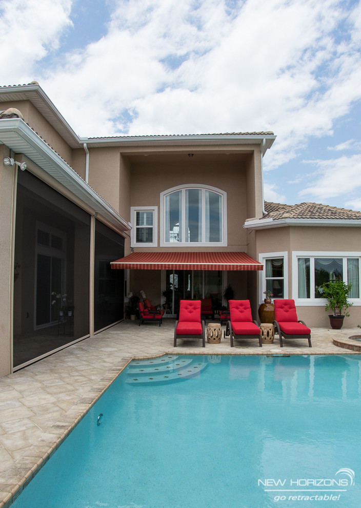 Inspiration for a contemporary back patio in Orlando with an awning.