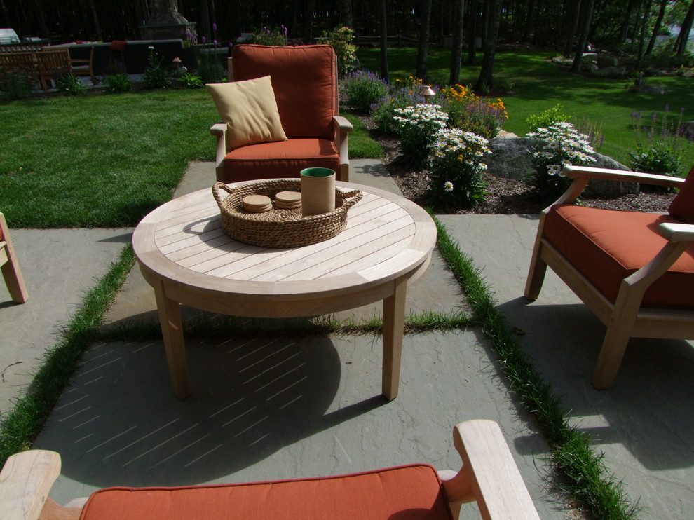 Inspiration for a large classic back patio in Boston with natural stone paving and no cover.