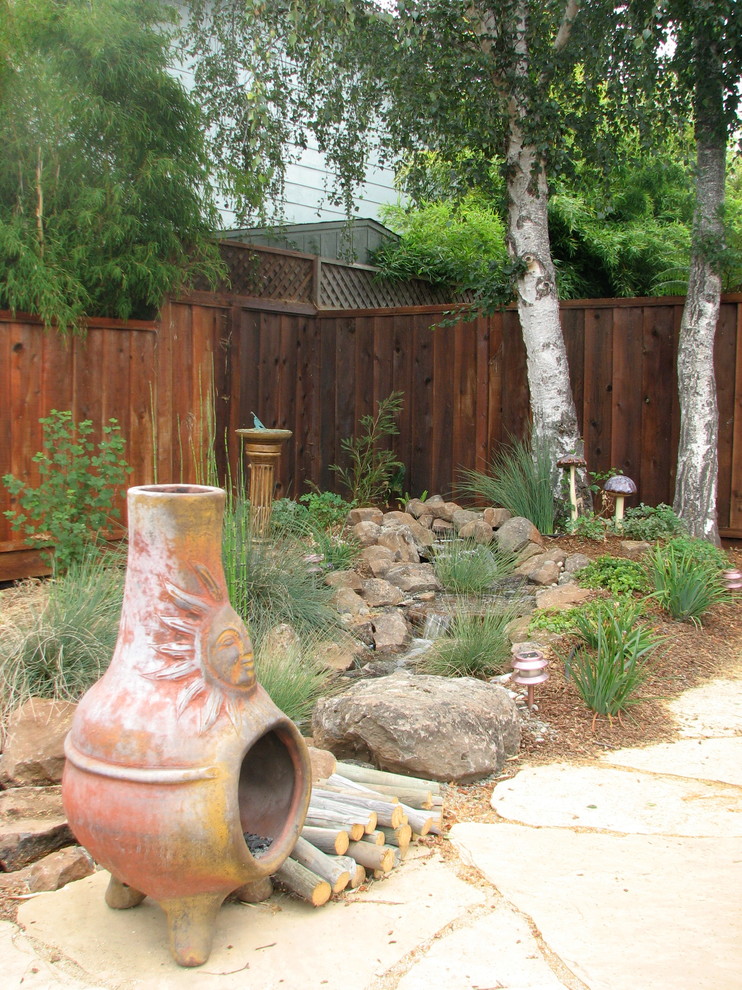 Foto de patio de estilo americano pequeño en patio delantero con fuente y adoquines de piedra natural