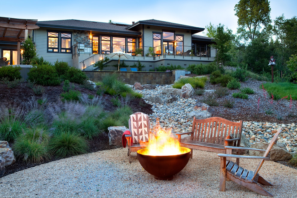 Contemporary patio in Other with a fire feature and gravel.