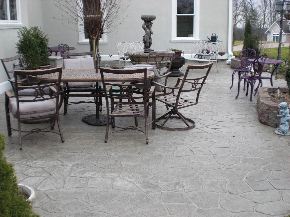 Traditional front patio in Other with a water feature, stamped concrete and no cover.