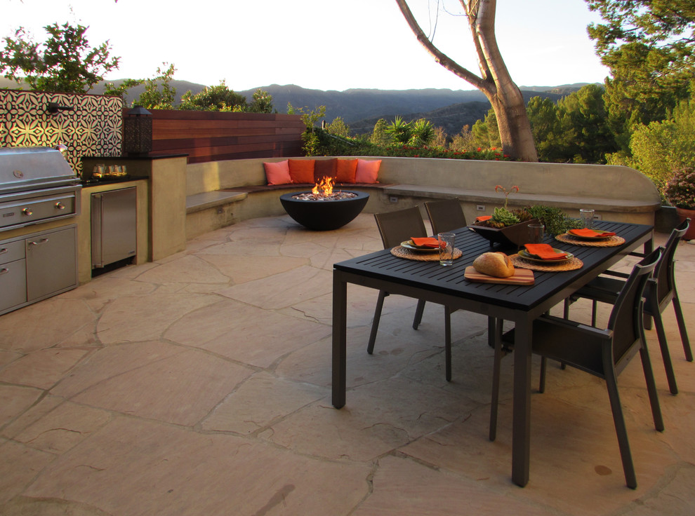 Medium sized contemporary courtyard patio in Los Angeles with natural stone paving.