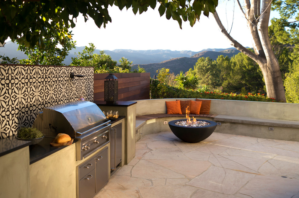 Example of a mid-sized trendy stone patio design in Los Angeles with no cover