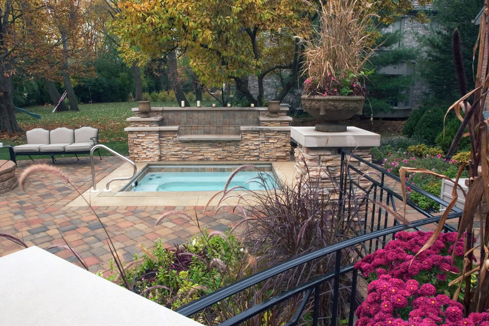 Inspiration for a mid-sized eclectic backyard concrete paver patio fountain remodel in Chicago with no cover