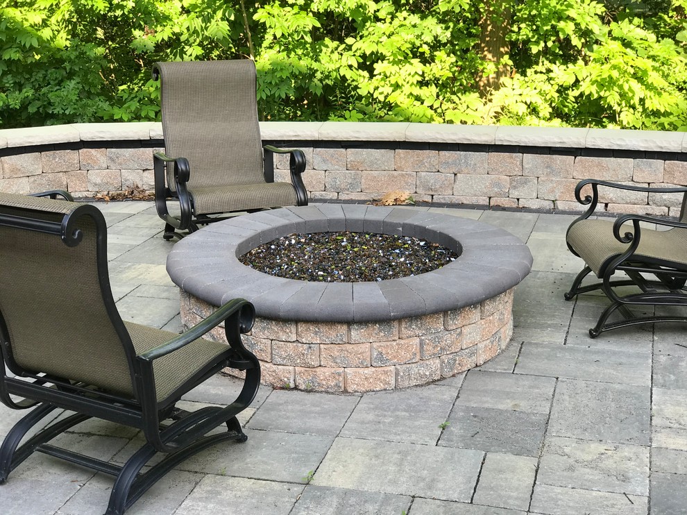 Patio - huge traditional backyard stamped concrete patio idea in Other with a fire pit and no cover