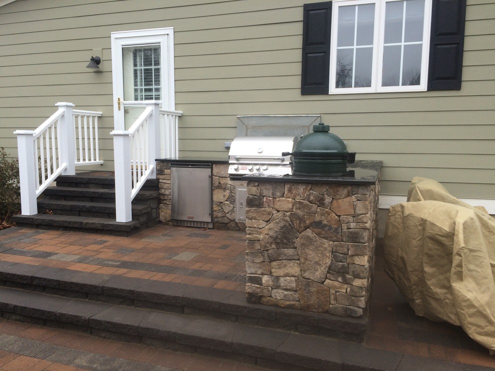 Example of a small classic side yard concrete paver patio kitchen design in Other
