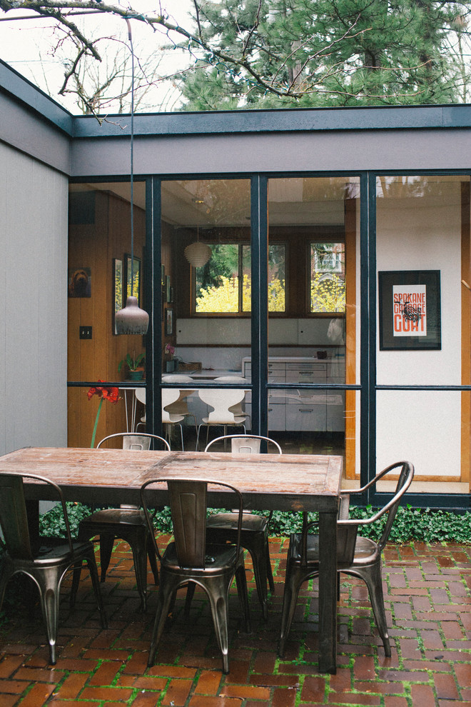 Inspiration for a medium sized midcentury courtyard patio in Seattle with brick paving and no cover.