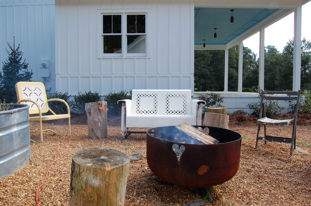 Example of a cottage chic patio design in New York with a fire pit